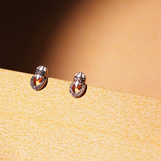 These refined rose gold earrings from jnjbymadhuri display a stunning dual-loop silhouette, adorned with shimmering stones. Their minimal yet graceful charm makes them a versatile choice for both everyday elegance and special occasions.