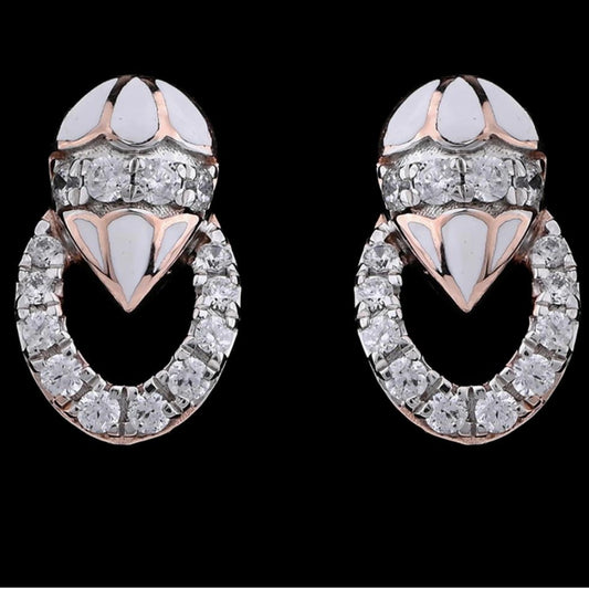 A close-up image of intricately designed earrings from jnjbymadhuri, featuring a luxurious combination of white enamel and sparkling diamonds arranged in a looped pattern, showcasing the brand's signature elegance and craftsmanship against a sleek black background.
