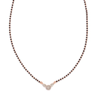 A modern take on tradition—this mangalsutra features a delicate black beaded chain with a minimalist diamond pendant at its center. A graceful and meaningful piece by jnjbymadhuri.
