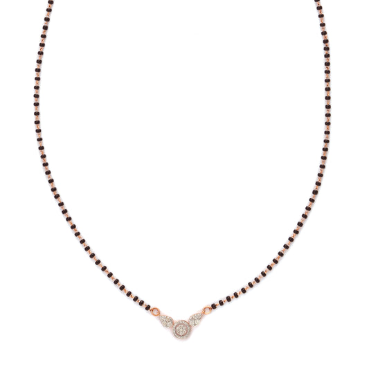 A modern take on tradition—this mangalsutra features a delicate black beaded chain with a minimalist diamond pendant at its center. A graceful and meaningful piece by jnjbymadhuri.
