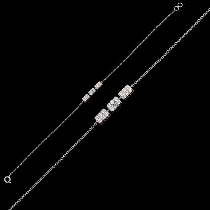 Sleek silver bracelet from jnjbymadhuri featuring three geometric diamond-studded cube charms on a fine chain, displayed on a black background for a modern, elegant look.
