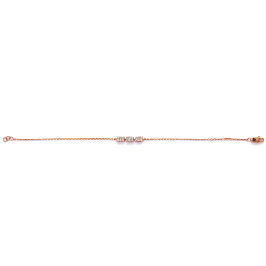 Minimalist bracelet from jnjbymadhuri featuring three sparkling cubic charms on a delicate rose gold chain, displayed on a white background.
