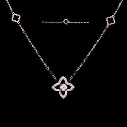 "Stylish rose gold mangalsutra necklace with a diamond-studded floral pendant and black beads, shown against a black background with matching floral motifs on the chain by jnjbymadhuri."
