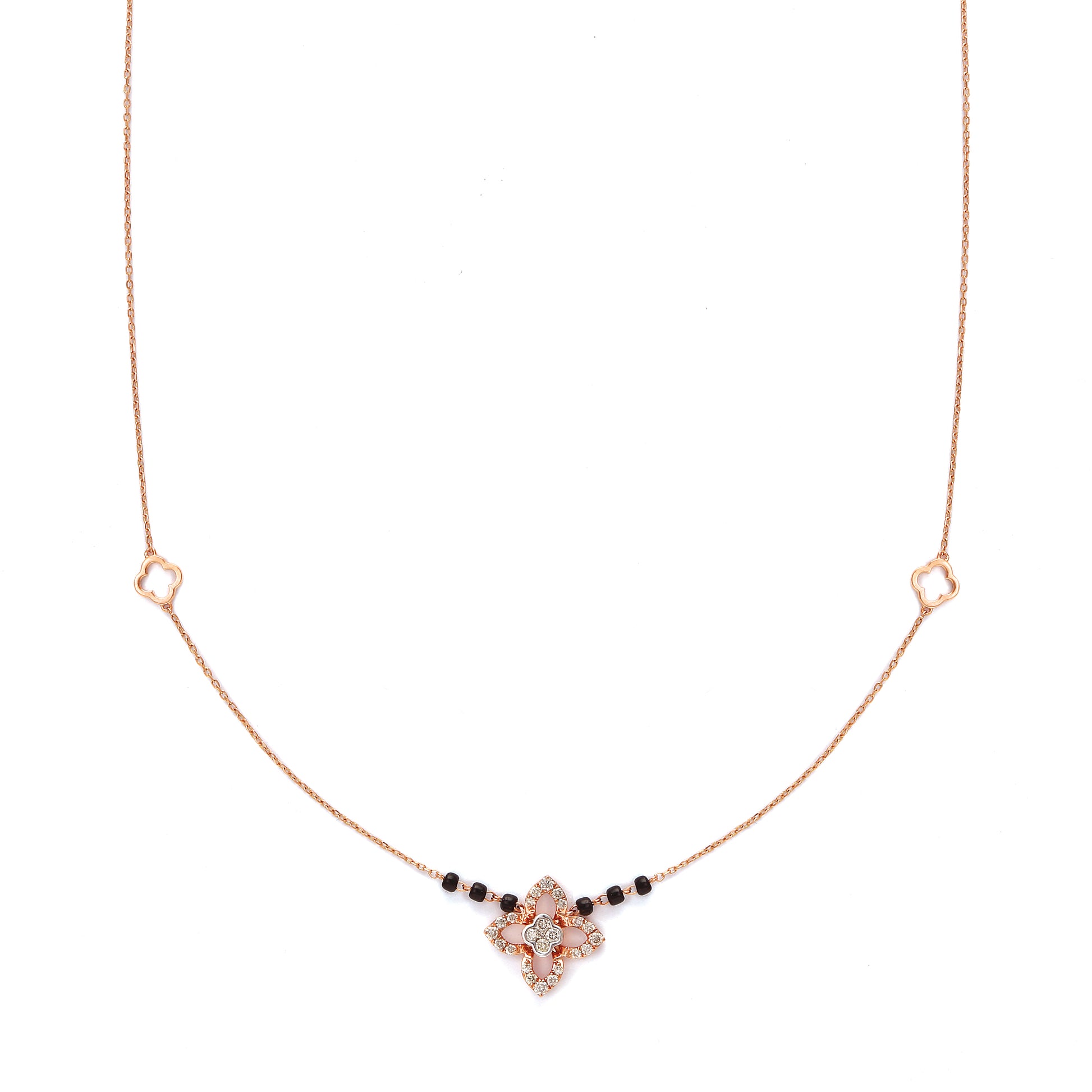 "Elegant rose gold mangalsutra necklace by jnjbymadhuri, featuring a floral pendant design with black beads on a delicate chain, displayed on a white background."
