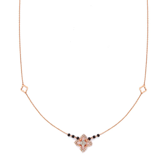 "Elegant rose gold mangalsutra necklace by jnjbymadhuri, featuring a floral pendant design with black beads on a delicate chain, displayed on a white background."

