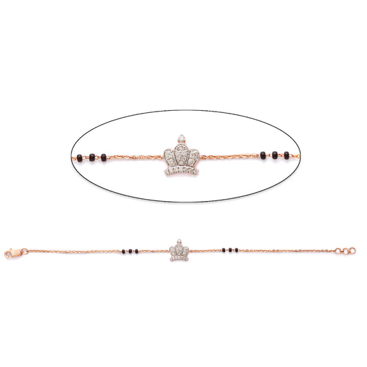 Stylish bracelet from jnjbymadhuri featuring a crown-shaped diamond centerpiece and traditional black beads, blending elegance with cultural charm.
