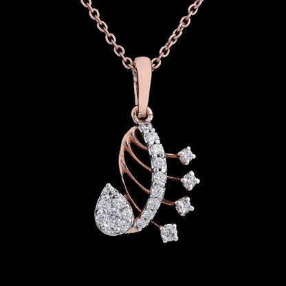 Close-up of a rose gold paisley-shaped pendant necklace by jnjbymadhuri, featuring intricate design with white stones and hanging diamond-like elements, set against a black background.
