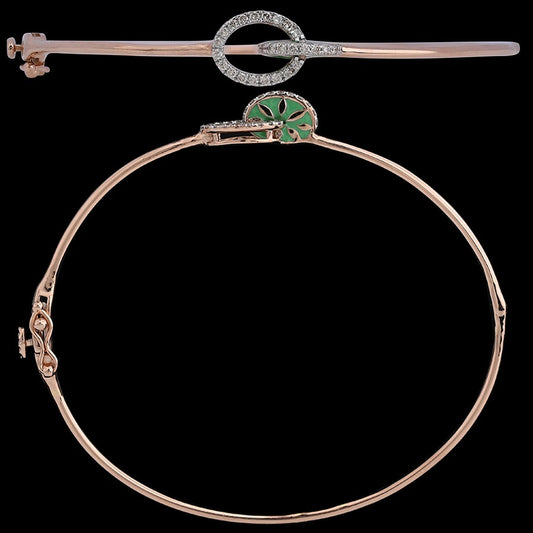 Elegant rose gold bracelet with a diamond-studded circular motif and delicate green enamel detailing. A refined statement piece by jnjbymadhuri.
