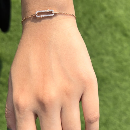 A stylish and elegant bracelet by jnjbymadhuri, showcased on the wrist with a minimalist yet striking rectangular design centerpiece, delicately set in rose gold and accented with shimmering stones—perfect for a graceful and modern look.
