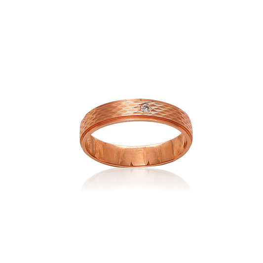 Elegant rose gold band with a textured finish and a single sparkling diamond at its center, perfect for timeless sophistication. Designed with finesse by jnjbymadhuri.
