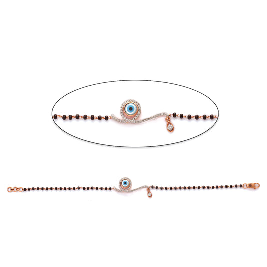 Stylish mangalsutra bracelet featuring an evil eye charm and classic black beads, designed for protection and elegance. A modern twist on tradition by jnjbymadhuri.
