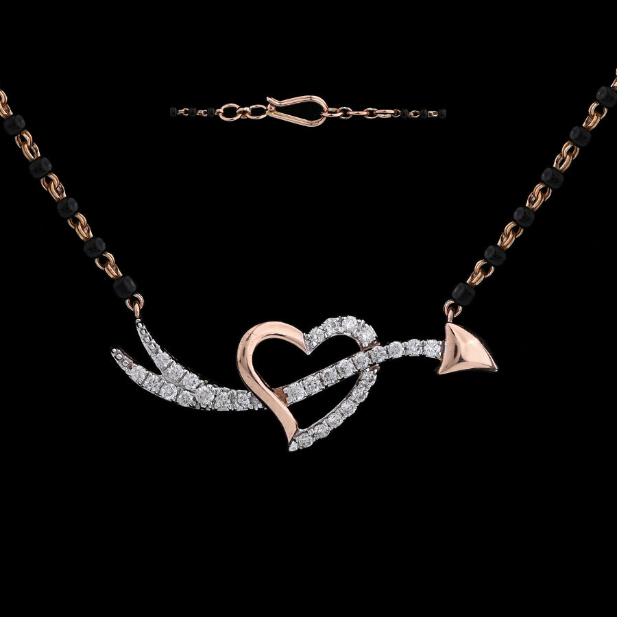Elegant heart and arrow diamond mangalsutra with black and gold dual-tone chain, symbolizing love's journey. A statement of modern romance by jnjbymadhuri.
