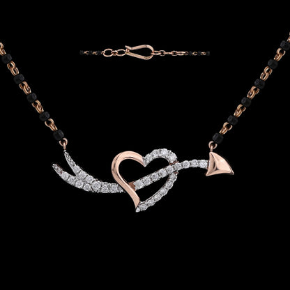 Elegant heart and arrow diamond mangalsutra with black and gold dual-tone chain, symbolizing love's journey. A statement of modern romance by jnjbymadhuri.

