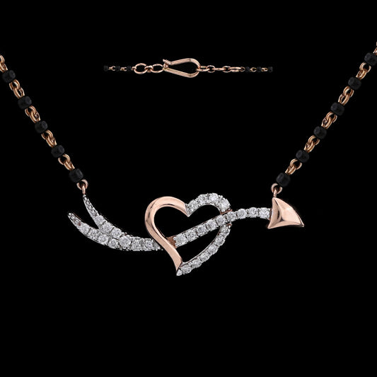 Elegant heart and arrow diamond mangalsutra with black and gold dual-tone chain, symbolizing love's journey. A statement of modern romance by jnjbymadhuri.
