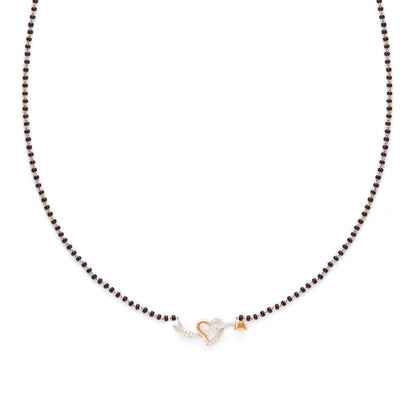 Delicate heart-shaped diamond mangalsutra pendant with classic black beaded chain, symbolizing timeless love. Crafted with elegance and grace by jnjbymadhuri.
