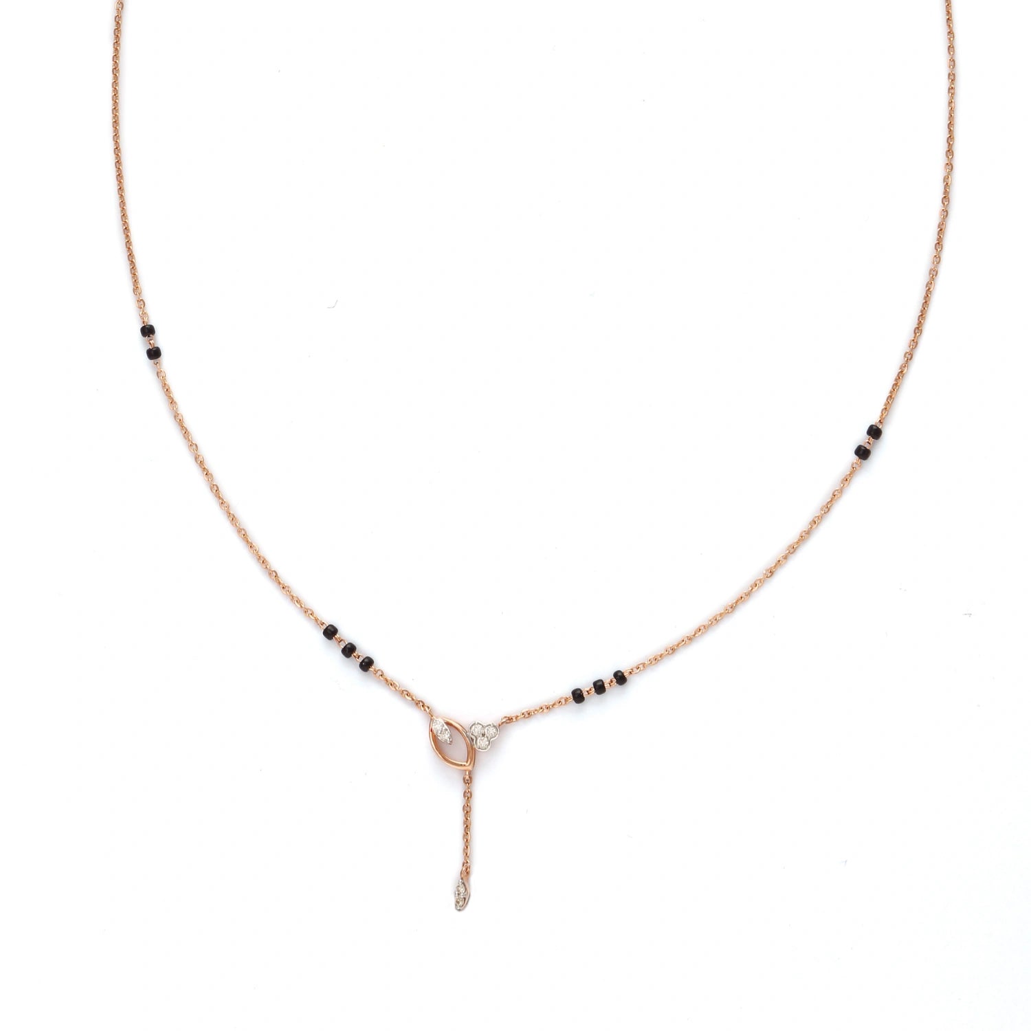 Minimalist mangalsutra with a delicate rose gold chain, accented by small black beads and featuring a central knot-like pendant with a vertical drop element, displayed on a white background.
