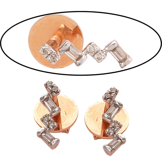 These modern geometric studs from jnjbymadhuri feature a striking zig-zag pattern with alternating baguette and round-cut stones, set in a warm gold base — a bold yet elegant statement perfect for any occasion.