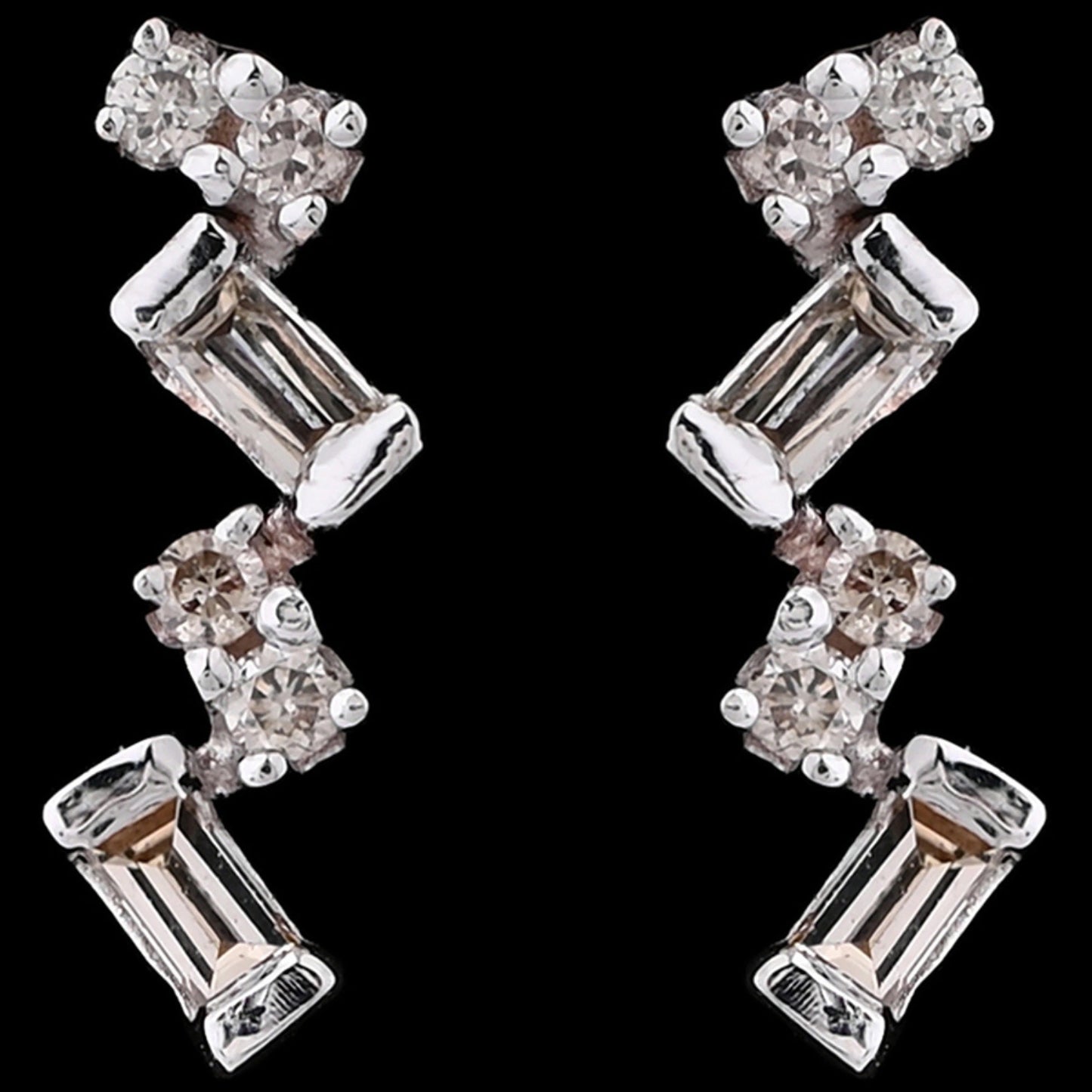 These elongated zig-zag earrings from jnjbymadhuri bring a contemporary edge with their alternating baguette and round-cut stones, creating a radiant and stylish shimmer that elevates both casual and formal looks.
