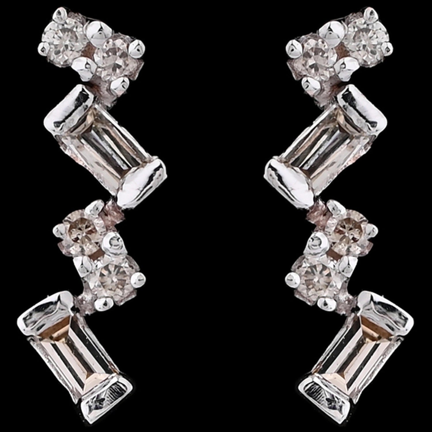 These elongated zig-zag earrings from jnjbymadhuri bring a contemporary edge with their alternating baguette and round-cut stones, creating a radiant and stylish shimmer that elevates both casual and formal looks.
