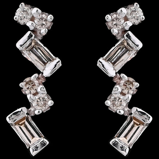 These elongated zig-zag earrings from jnjbymadhuri bring a contemporary edge with their alternating baguette and round-cut stones, creating a radiant and stylish shimmer that elevates both casual and formal looks.
