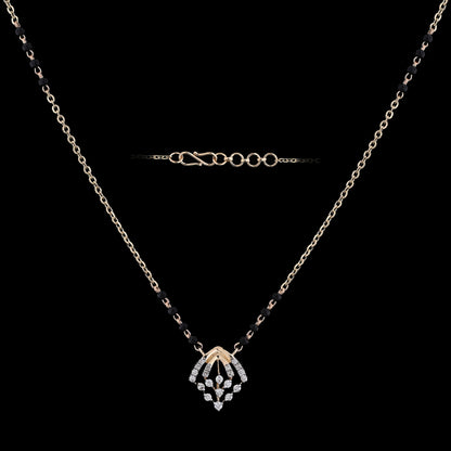 Elegant mangalsutra necklace featuring a delicate diamond-studded pendant and black bead detailing, perfect for modern traditional wear. This graceful design by jnjbymadhuri blends timeless charm with contemporary elegance.
