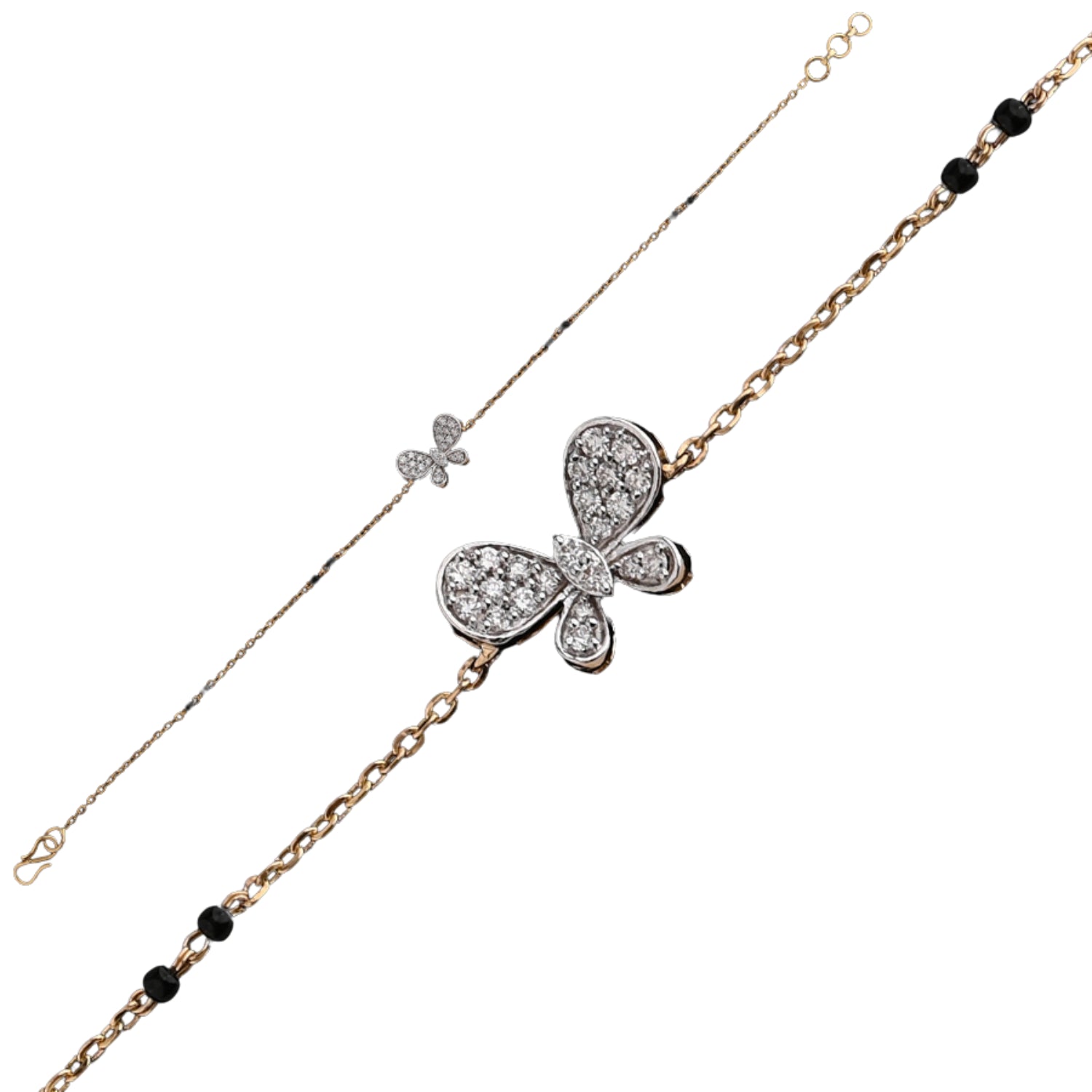 A delicate and elegant bracelet by jnjbymadhuri, featuring a charming butterfly centerpiece encrusted with sparkling diamonds. The bracelet combines a fine dual-tone chain—one side in sleek white metal and the other in warm yellow gold—accented with small black beads for a graceful contrast. This refined piece showcases intricate craftsmanship and a whimsical yet sophisticated design.
