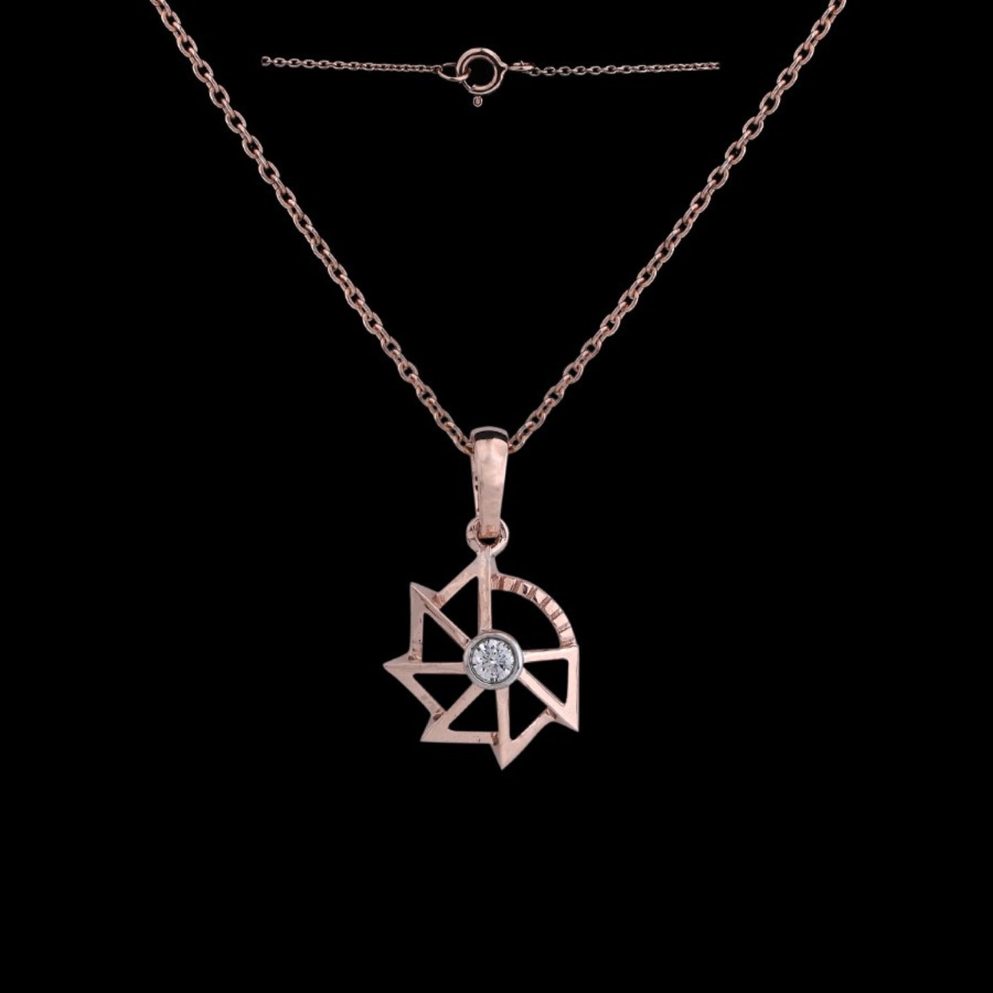 Rose gold pendant necklace by jnjbymadhuri, featuring a modern geometric star design with a central diamond, showcased against a black background with its delicate chain and clasp visible.
