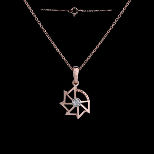 Rose gold pendant necklace by jnjbymadhuri, featuring a modern geometric star design with a central diamond, showcased against a black background with its delicate chain and clasp visible.
