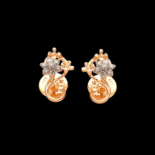 Elegant floral stud earrings by jnjbymaduri, crafted in gold and adorned with radiant diamond clusters, offering a timeless design for graceful sophistication.