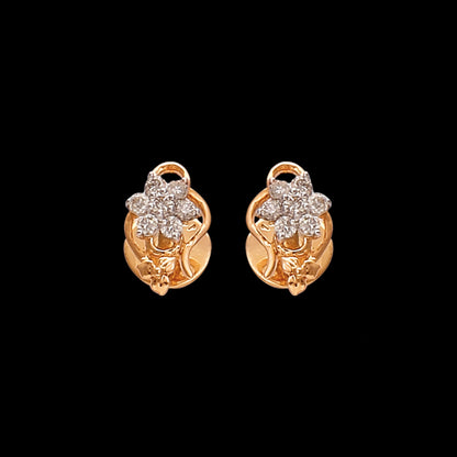Gold floral stud earrings by jnjbymaduri, adorned with shimmering diamonds arranged in a flower motif, exuding timeless charm and sophistication suitable for both everyday wear and special occasions.
