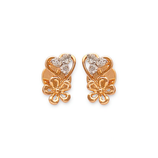 These elegant gold stud earrings by jnjbymadhuri showcase a charming heart-shaped design paired with a delicate floral motif, adorned with sparkling diamonds that add a touch of timeless grace and femininity.