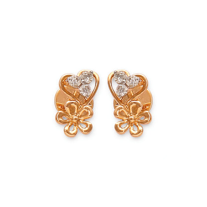 These elegant gold stud earrings by jnjbymadhuri showcase a charming heart-shaped design paired with a delicate floral motif, adorned with sparkling diamonds that add a touch of timeless grace and femininity.
