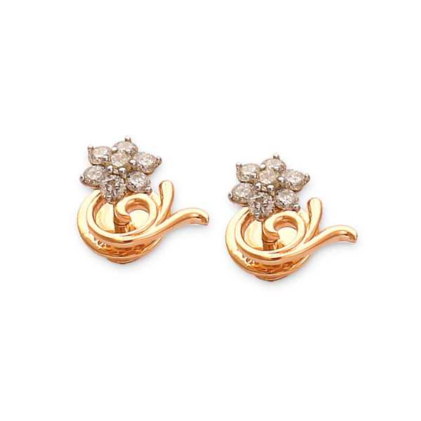 a pair of floral-inspired gold earrings featuring a star-shaped diamond cluster atop a graceful gold swirl — jewelry by jnjbymadhuri.
