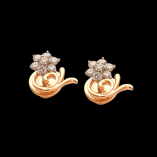 a pair of elegant gold earrings with star-shaped diamond clusters and flowing gold accents — jewelry by jnjbymadhuri.
