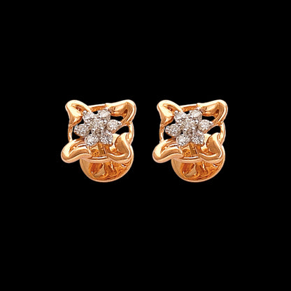 Stunning floral-inspired gold stud earrings designed by jnjbymadhuri, featuring a delicate four-petal motif with sparkling diamond accents, perfect for adding an elegant touch to both everyday and festive looks.

