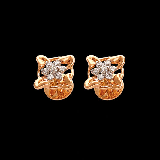 Stunning floral-inspired gold stud earrings designed by jnjbymadhuri, featuring a delicate four-petal motif with sparkling diamond accents, perfect for adding an elegant touch to both everyday and festive looks.
