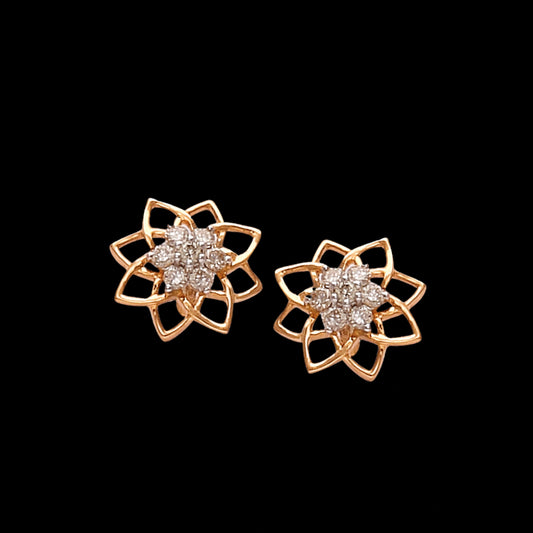 A stunning pair of floral stud earrings with a geometric petal motif and radiant diamonds at the center, crafted with precision and elegance by jnjbymadhuri—perfect for adding a graceful sparkle to any look.
