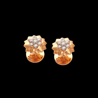 Golden floral stud earrings adorned with shimmering diamonds, radiating grace and elegance—an exquisite creation by jnjbymadhuri perfect for timeless sophistication.
