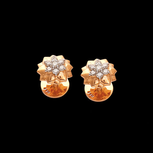 Golden floral stud earrings adorned with shimmering diamonds, radiating grace and elegance—an exquisite creation by jnjbymadhuri perfect for timeless sophistication.
