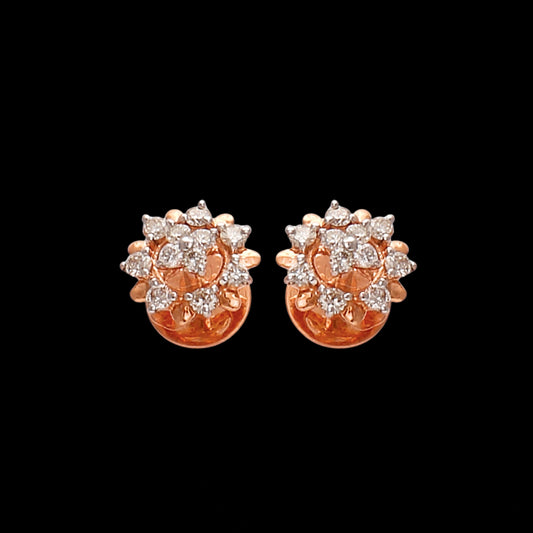 a pair of rose gold floral stud earrings with sparkling clustered diamonds on a black background — jewelry by jnjbymadhuri.
