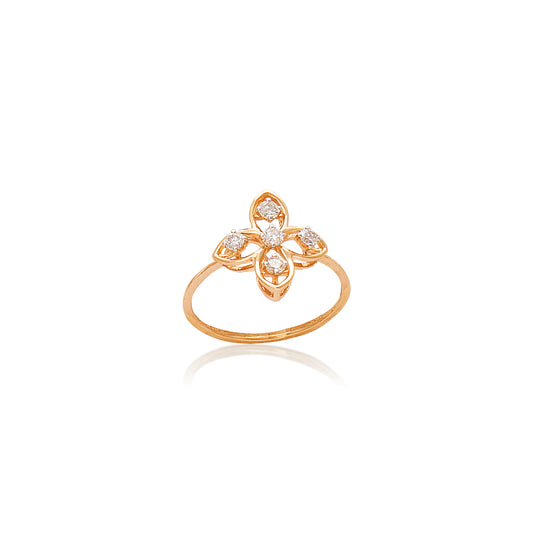 Gold ring featuring a symmetrical floral design with four petal-shaped diamond settings, displayed against a white background with a soft reflection.
