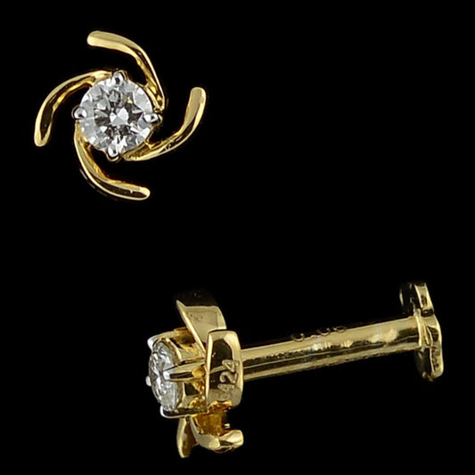 Modern gold stud earring with a dazzling diamond encased in a dynamic swirl pattern. A bold and stylish piece by jnjbymadhuri.
