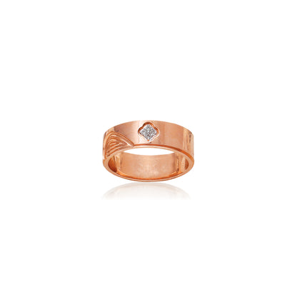 This sleek rose gold ring by jnjbymadhuri showcases a contemporary band design with a single embedded diamond, offering a perfect blend of minimalism and sophistication for everyday elegance.
