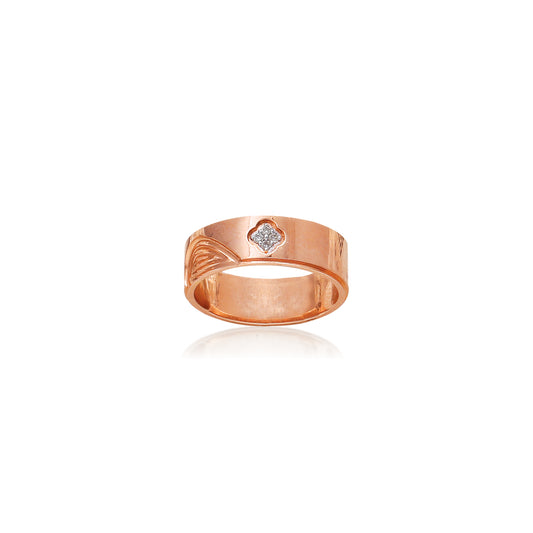 This sleek rose gold ring by jnjbymadhuri showcases a contemporary band design with a single embedded diamond, offering a perfect blend of minimalism and sophistication for everyday elegance.
