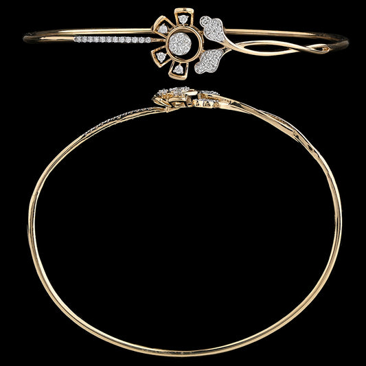 Elegant floral-themed gold bangle featuring petal-shaped embellishments and delicate stone detailing. An exquisite piece by jnjbymadhuri.
