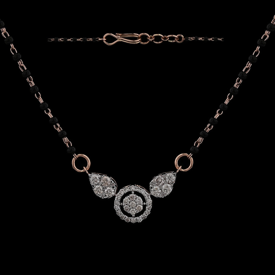 Elegant mangalsutra with diamond-studded circular and teardrop motifs on a dual black-beaded chain, exuding timeless charm. A signature creation by jnjbymadhuri blending tradition with modern elegance.
