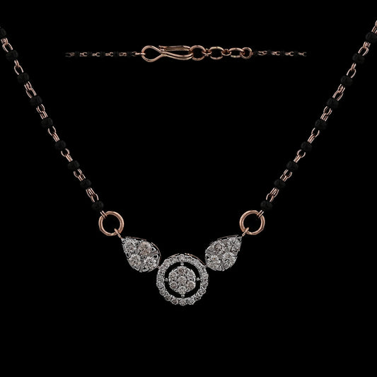 Elegant mangalsutra with diamond-studded circular and teardrop motifs on a dual black-beaded chain, exuding timeless charm. A signature creation by jnjbymadhuri blending tradition with modern elegance.
