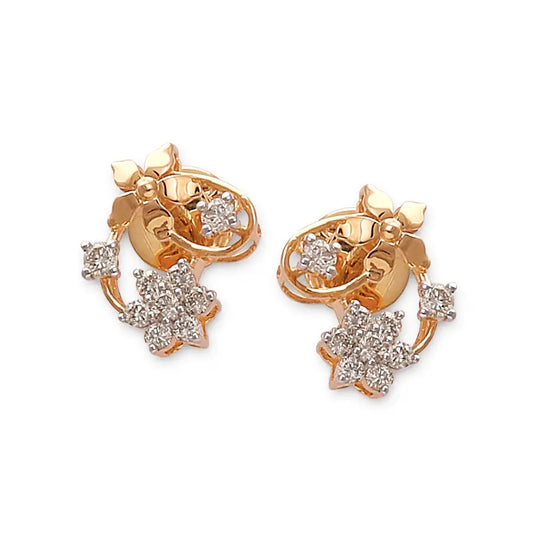Exquisite gold floral stud earrings adorned with intricate leaf details and dazzling diamond clusters. A nature-inspired masterpiece by jnjbymadhuri.
