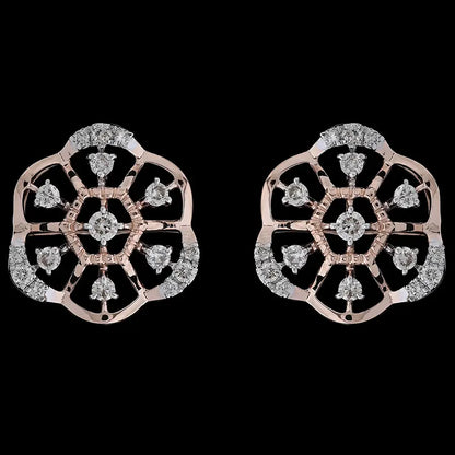 Intricately designed floral motif earrings in rose gold, highlighted with sparkling white stones arranged in a symmetrical pattern. These artistic studs by jnjbymadhuri bring a touch of tradition with contemporary elegance.
