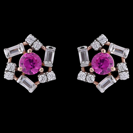 These floral-inspired earrings by jnjbymadhuri feature vivid fuchsia center stones surrounded by shimmering baguette and round-cut crystals in a delicate rose gold setting. A perfect blend of bold color and refined sparkle, ideal for both festive occasions and elegant everyday wear.
